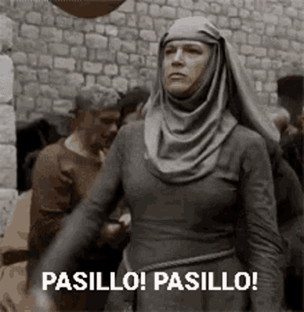 a woman in a hijab is standing in front of a brick wall and says pasillo ! pasillo !