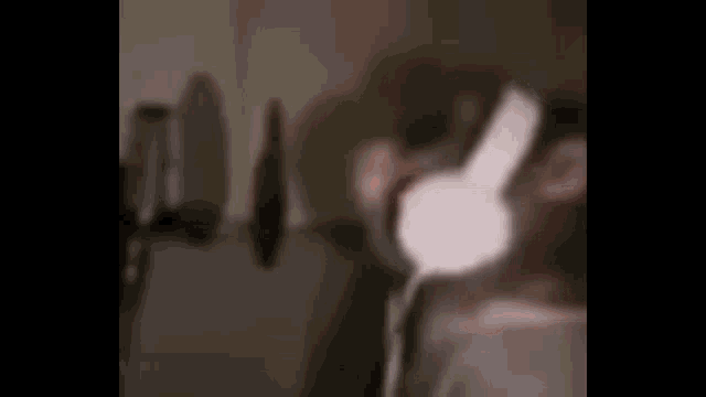 a person wearing headphones in a dark room .