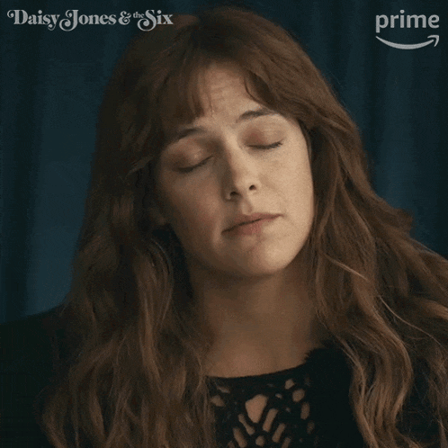 a close up of a woman 's face with the words daisy jones & the six on the bottom