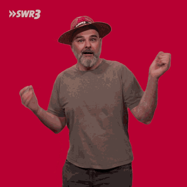 a man with a beard wearing a red hat with swr3 written on it