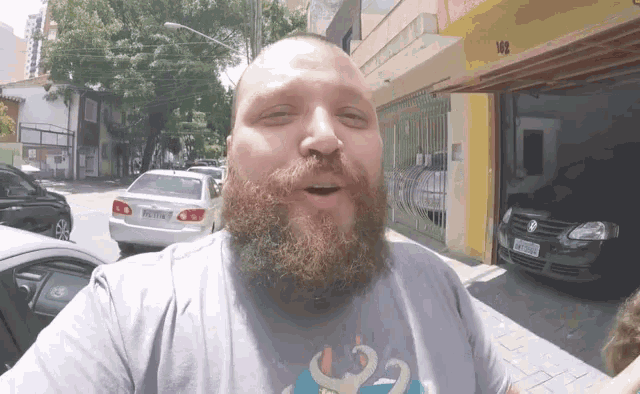 a man with a beard is wearing a shirt that says 102
