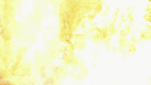 a large fire is coming out of a window