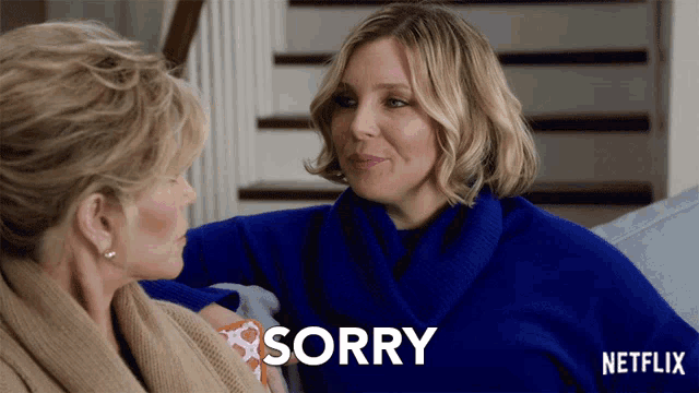 a netflix ad shows two women sitting on a couch and one says sorry