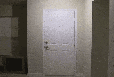 a white door in a hallway with a light shining on it