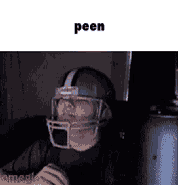 a person wearing a football helmet with the word peen written on it