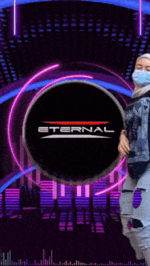 a woman wearing a face mask is dancing in front of a eternal logo