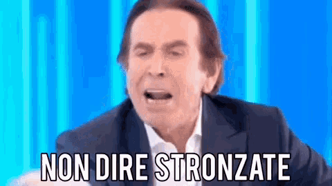 a man in a suit says " non dire stronzate " in front of a blue background