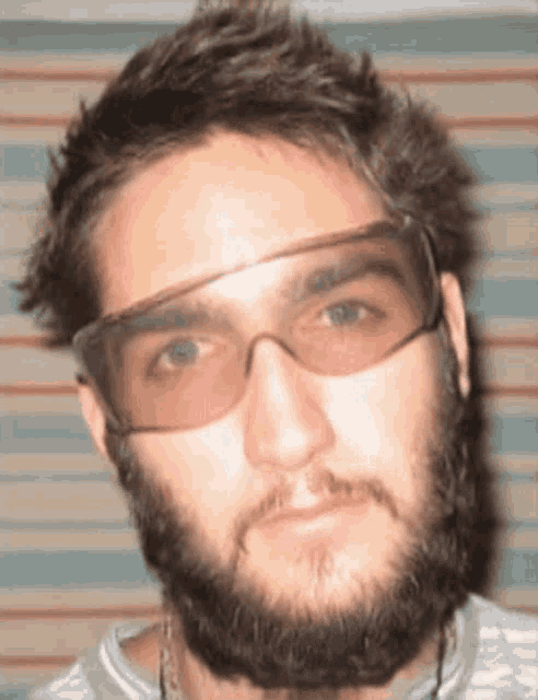a man with a beard wearing a pair of sunglasses