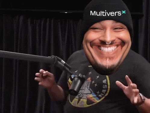 a man wearing headphones is laughing in front of a microphone while standing in front of a brick wall .