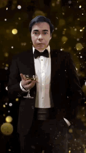 a man in a tuxedo is holding a glass of champagne and says cheers in yellow