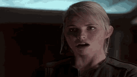 a close up of a woman making a surprised face
