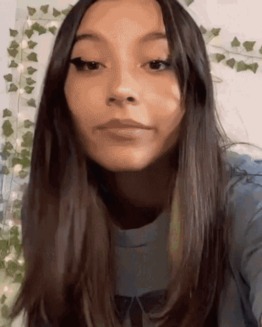 a close up of a woman 's face with long dark hair