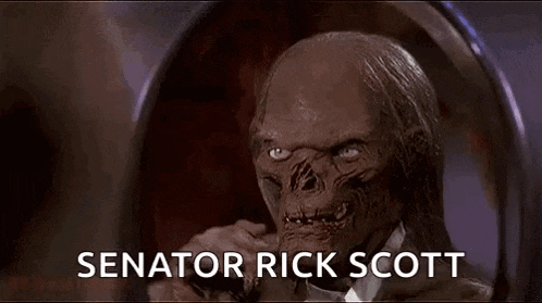 a mummy is sitting in a chair with the words `` senator rick scott '' written on the bottom .