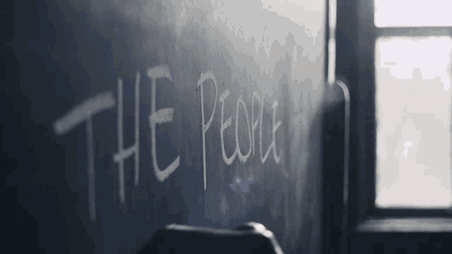 a blackboard with the words the people written in white chalk