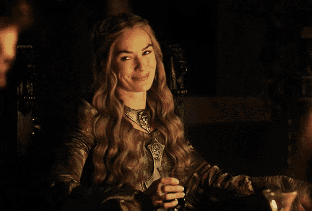 a woman sitting at a table with a glass of wine