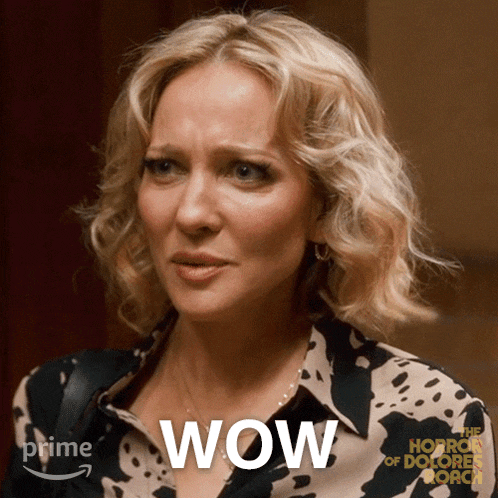 a woman with a surprised look on her face and the word wow behind her