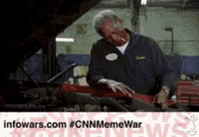 a man with blood on his face is working on a car ..