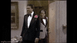 two men in tuxedos are standing next to each other