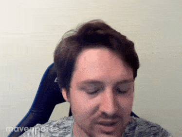 a man with a beard is sitting in a chair with the word mavenport on the bottom right