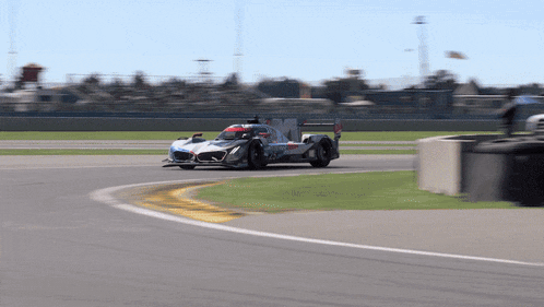 a race car is going around a curve on the track