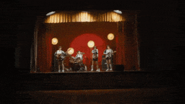 a girl is singing into a microphone with a band behind her