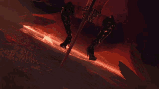 a woman in high heels is standing on a pole with a red background