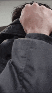 a close up of a person 's hand covering their mouth