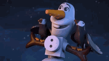 a lego snowman with a carrot in his nose is sitting on a tree branch with birds .