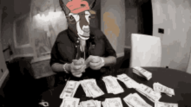 a man with a goat head is playing cards