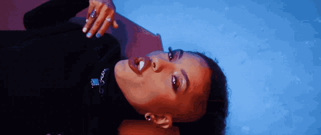 a woman in a black turtleneck laying on her back