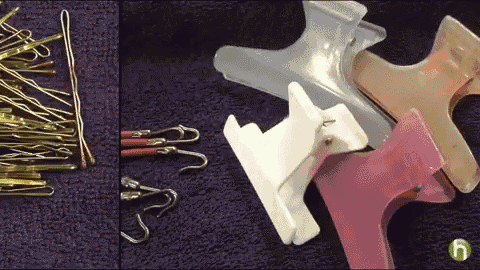 a bunch of hair clips on a purple cloth