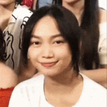 a close up of a woman 's face with a smile on her face
