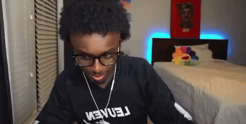 a young man wearing glasses and a black shirt that says ' tennem '