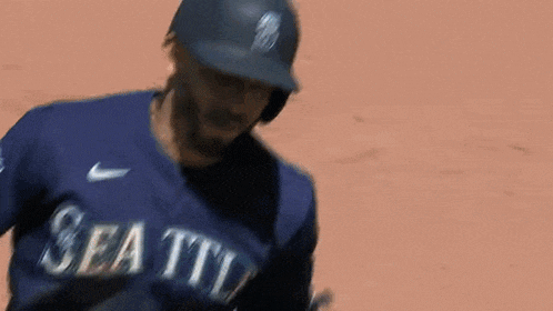 a baseball player wearing a helmet and gloves is standing on the field .