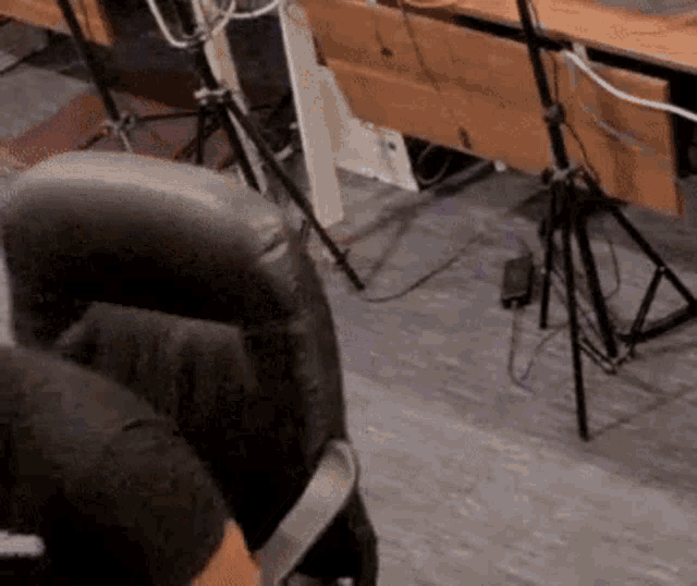 a man is sitting in a chair in front of a microphone in an office .