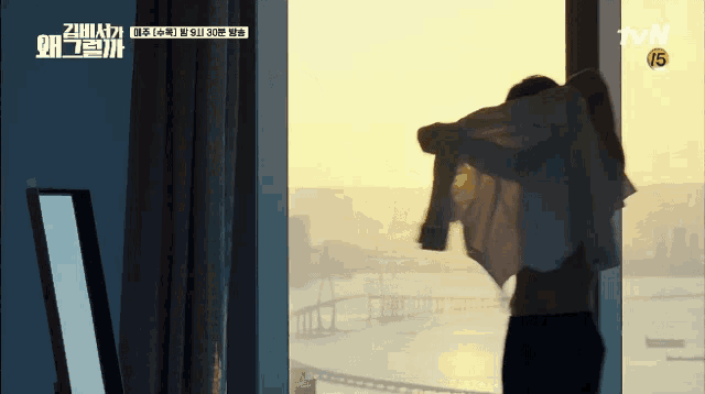 a man is standing in front of a window with a tvn logo above him
