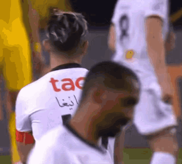 a man in a white shirt with the word tac on it