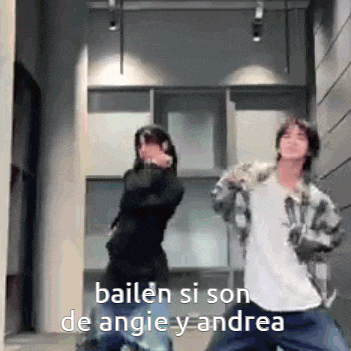 a man and a woman are dancing in a hallway .