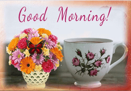 a bouquet of flowers sits next to a cup of coffee with the words good morning written on the bottom