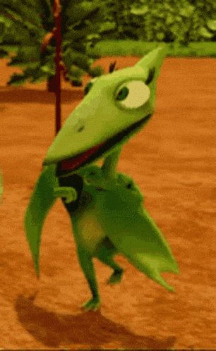 a green cartoon character is standing on a dirt ground
