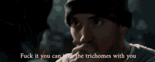 a man singing into a microphone with the words " fuck if you can take the trichomes with you " written below him