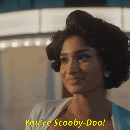 a woman with curlers in her hair says you 're scooby doo
