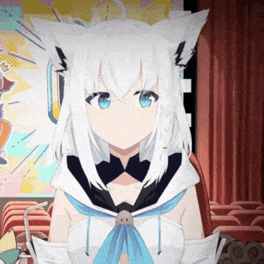 a girl with white hair and blue eyes is sitting in a theater