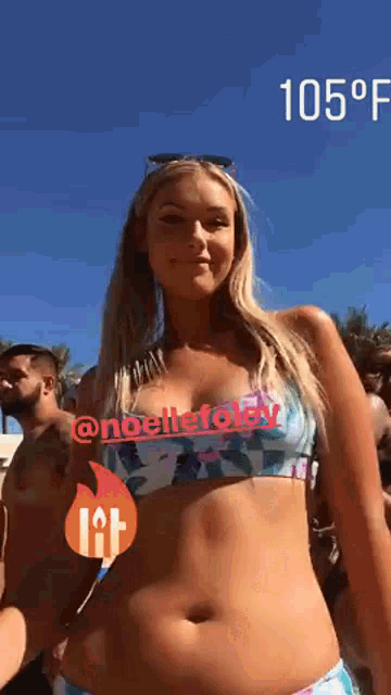 a woman in a bikini is standing in front of a group of people and the temperature is 105 degrees fahrenheit