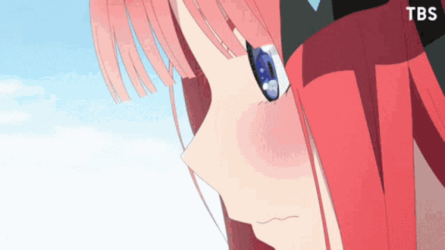 a close up of a girl 's face with a tbs logo behind her
