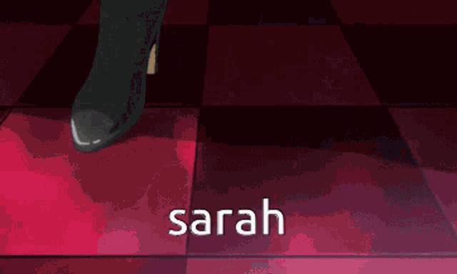 a man in a suit is standing in front of a couch with the name sarah on the bottom