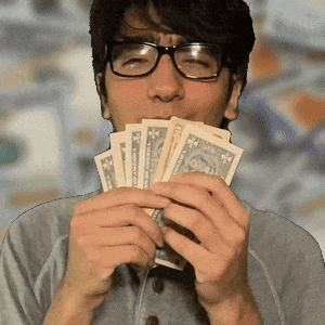 a man wearing glasses is holding a fan of 20 dollar bills