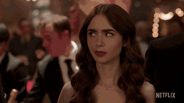 a woman with red lipstick and a necklace with netflix written on the bottom