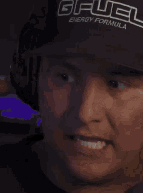 a man wearing a hat that says gfuel energy formula on it