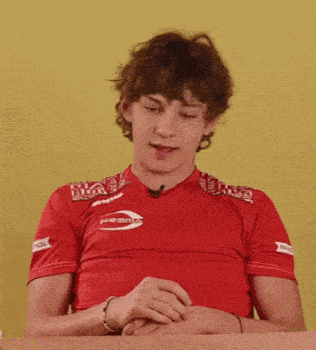 a young man wearing a red shirt that says prisma